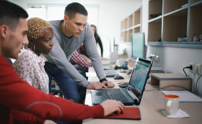 People looking at a laptop