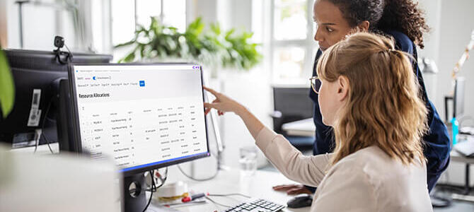 Two women looking at a computer screen in an office