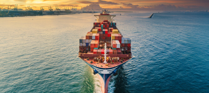 Container ship approaching port, representing global logistics and supply chain planning